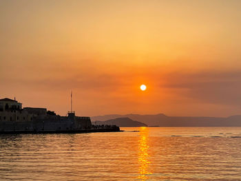 Scenic view of sea against orange sky