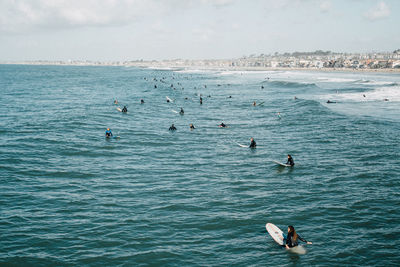 High angle view of people surfing in sea