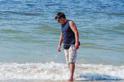 Full length of man standing on beach