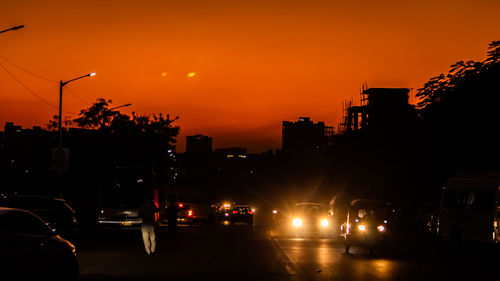 Traffic on road at sunset