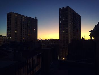 Buildings in city at sunset