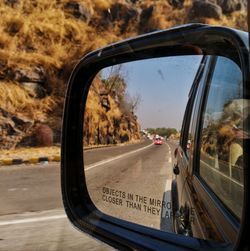 Close-up of side-view mirror of car