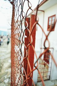 Close-up of chainlink fence against sky