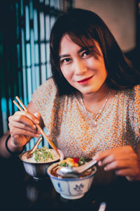 Portrait of woman eating food