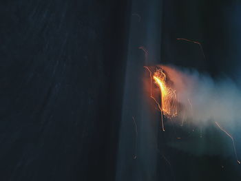 Close-up of illuminated fireworks against sky at night