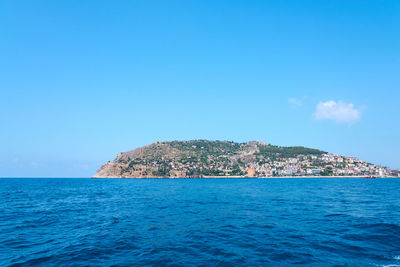 Scenic view of sea against blue sky
