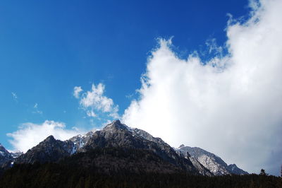 Scenic view of snowcapped mountains against blue sky