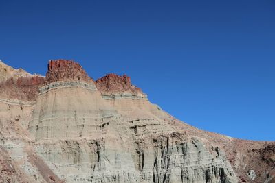 Rock formations on mountain against clear sky