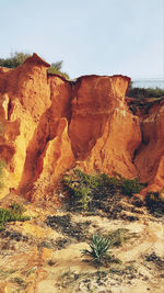 Rock formations on landscape against sky