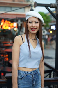 Portrait of beautiful woman looking standing in city