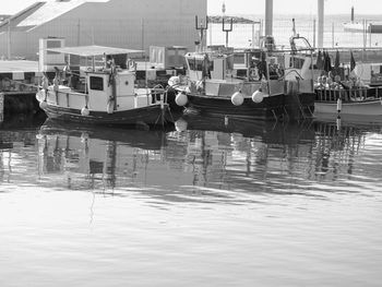 Fishing boats moored at harbor