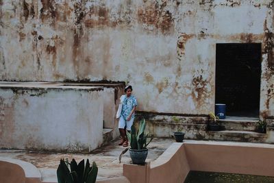 Man standing against old building