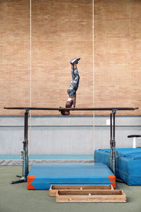 Full length of man jumping on wall