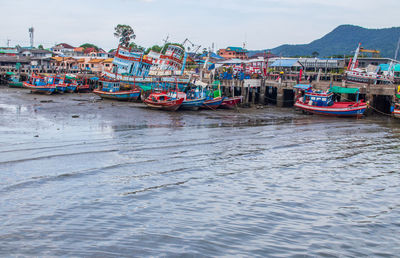 Boats moored in sea against sky