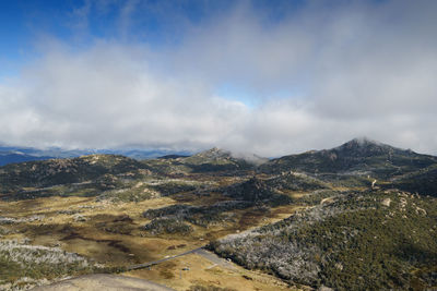 Scenic view of mountains against cloudy sky