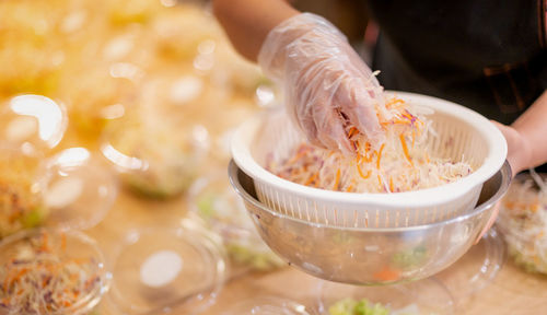 Close-up of hand holding soup in bowl