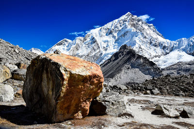 Scenic view of snowcapped mountains against blue sky