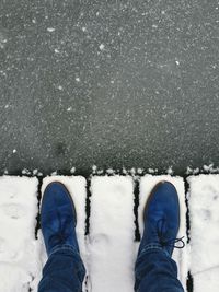Low section of person standing on tiled floor