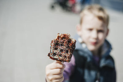 Close-up of waffle held by boy