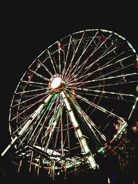 Low angle view of ferris wheel against sky at night