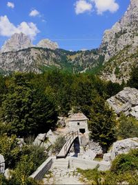 Scenic view of mountain and trees against sky