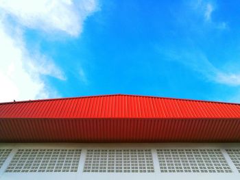 Low angle view of building against blue sky on sunny day