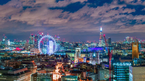 High angle view of illuminated cityscape against sky at night