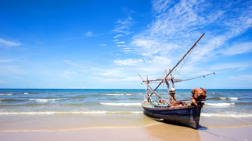 Fishing boat on a beach and deep bluesky background , landscape thailand