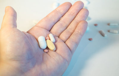 Close-up of hand holding pills