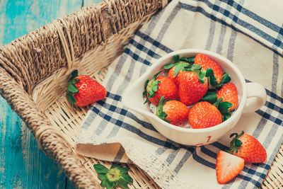 High angle view of strawberries in basket on table