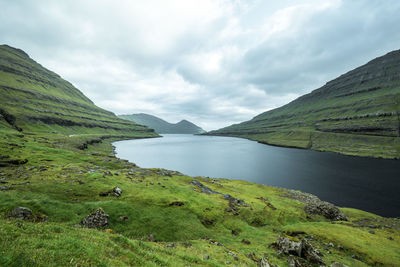 Scenic view of lake and mountains against sky