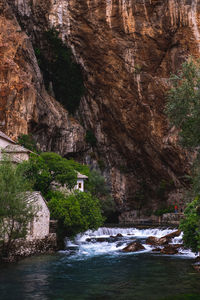 Scenic view of waterfall in mountains