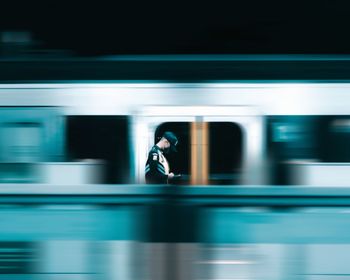 Blurred motion of train at railroad station