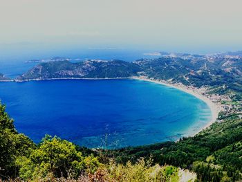 High angle view of sea and cityscape against sky