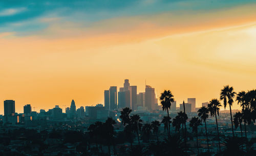 Panoramic view of buildings against sky during sunset