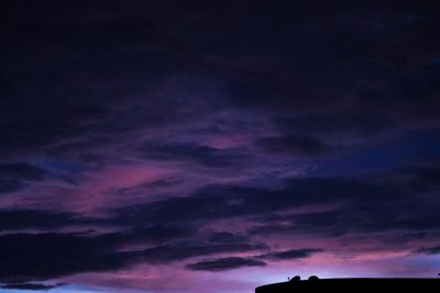 Low angle view of dramatic sky at night