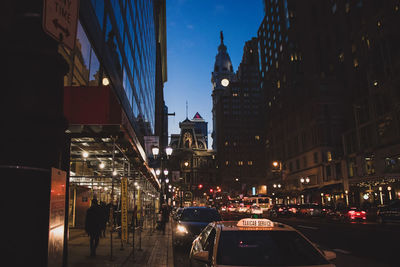 Traffic on city street and buildings at night