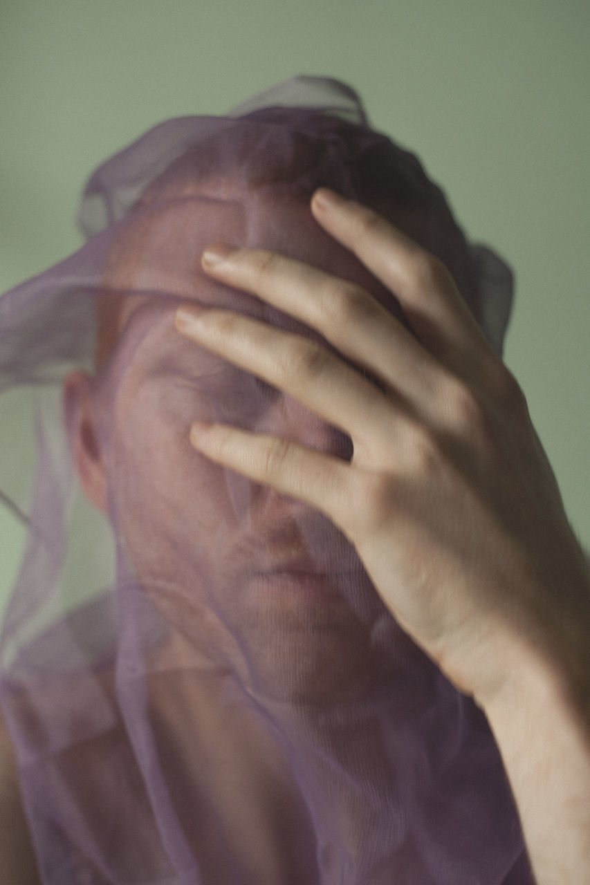 CLOSE-UP OF HUMAN HAND WITH FACE