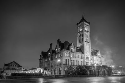 Low angle view of clock tower against sky at night