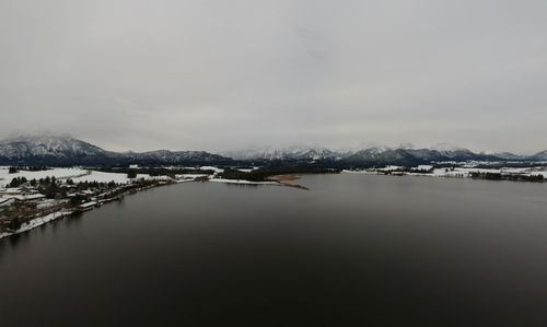 Scenic view of lake against sky during winter