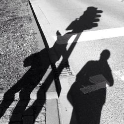 Shadow of people on road