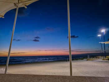 Scenic view of beach against blue sky