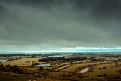 Scenic view of landscape against cloudy sky