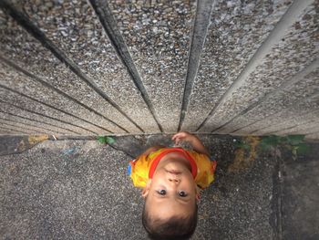High angle portrait of boy standing by wall