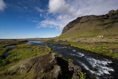 Scenic view of landscape against cloudy sky