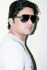 Portrait of young man wearing sunglasses against white background