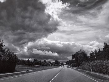 Empty road along countryside landscape