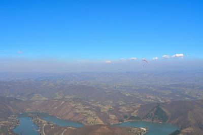 Aerial view of city against blue sky