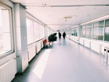 Rear view of men walking in corridor