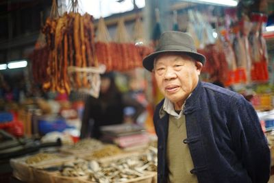 Portrait of smiling man at market stall
